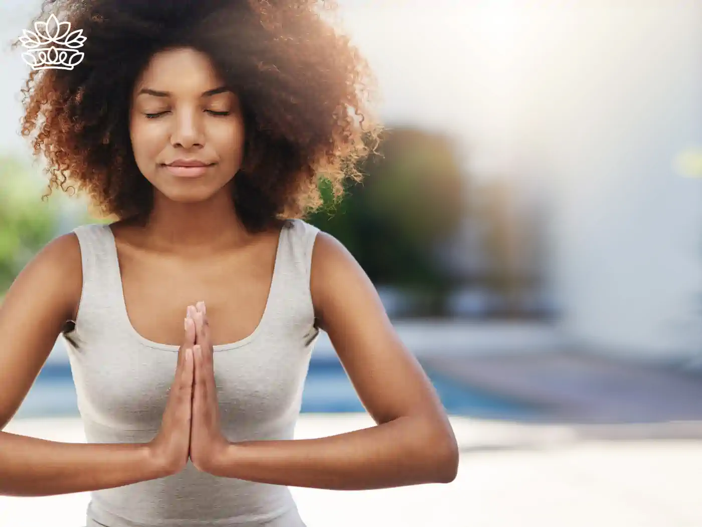 A woman meditating with her eyes closed, finding inner peace and mindfulness. Fabulous Flowers and Gifts - Health and Wellbeing Collection.