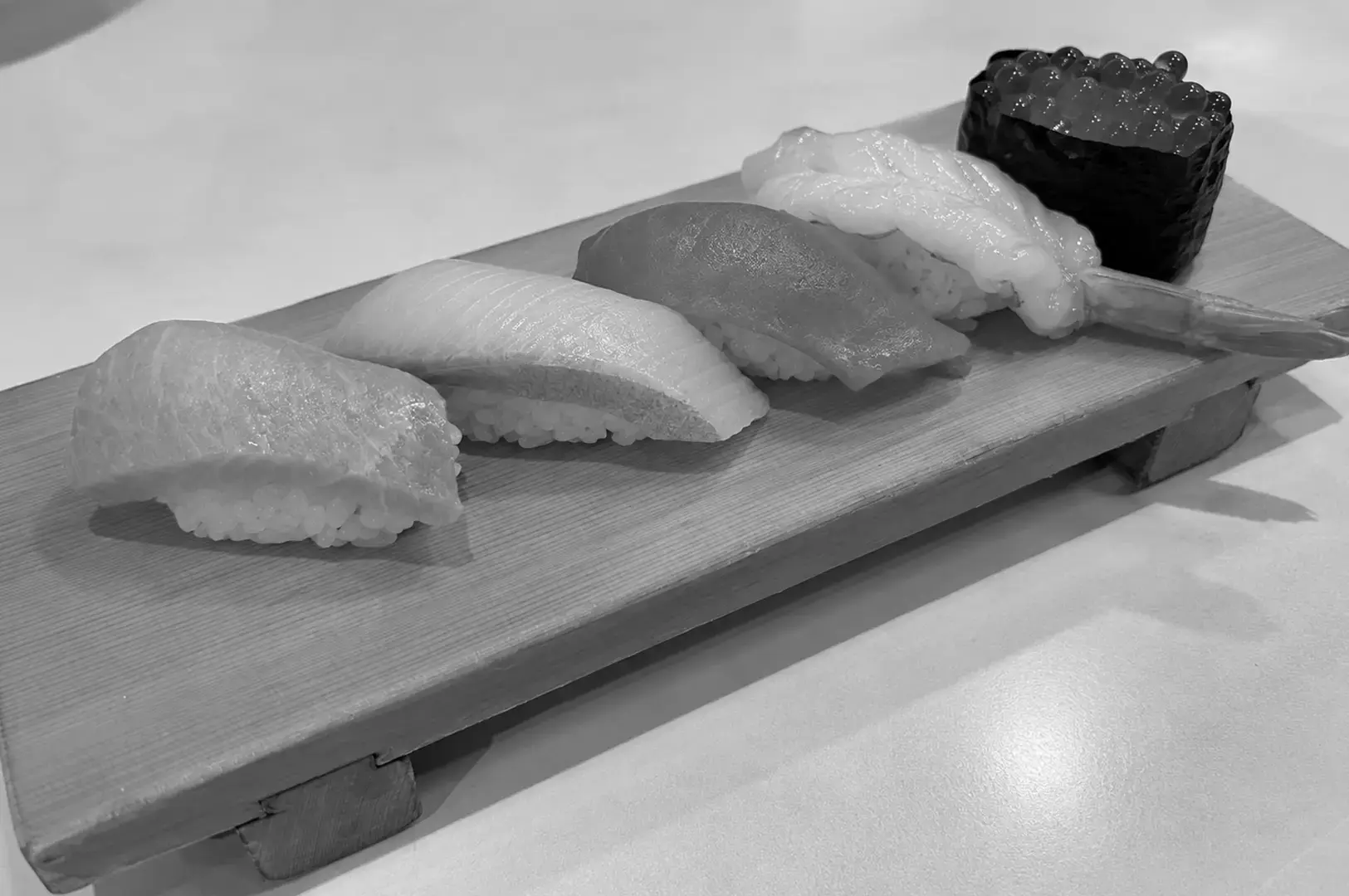Selection of premium nigiri sushi served on a wooden sushi board.
