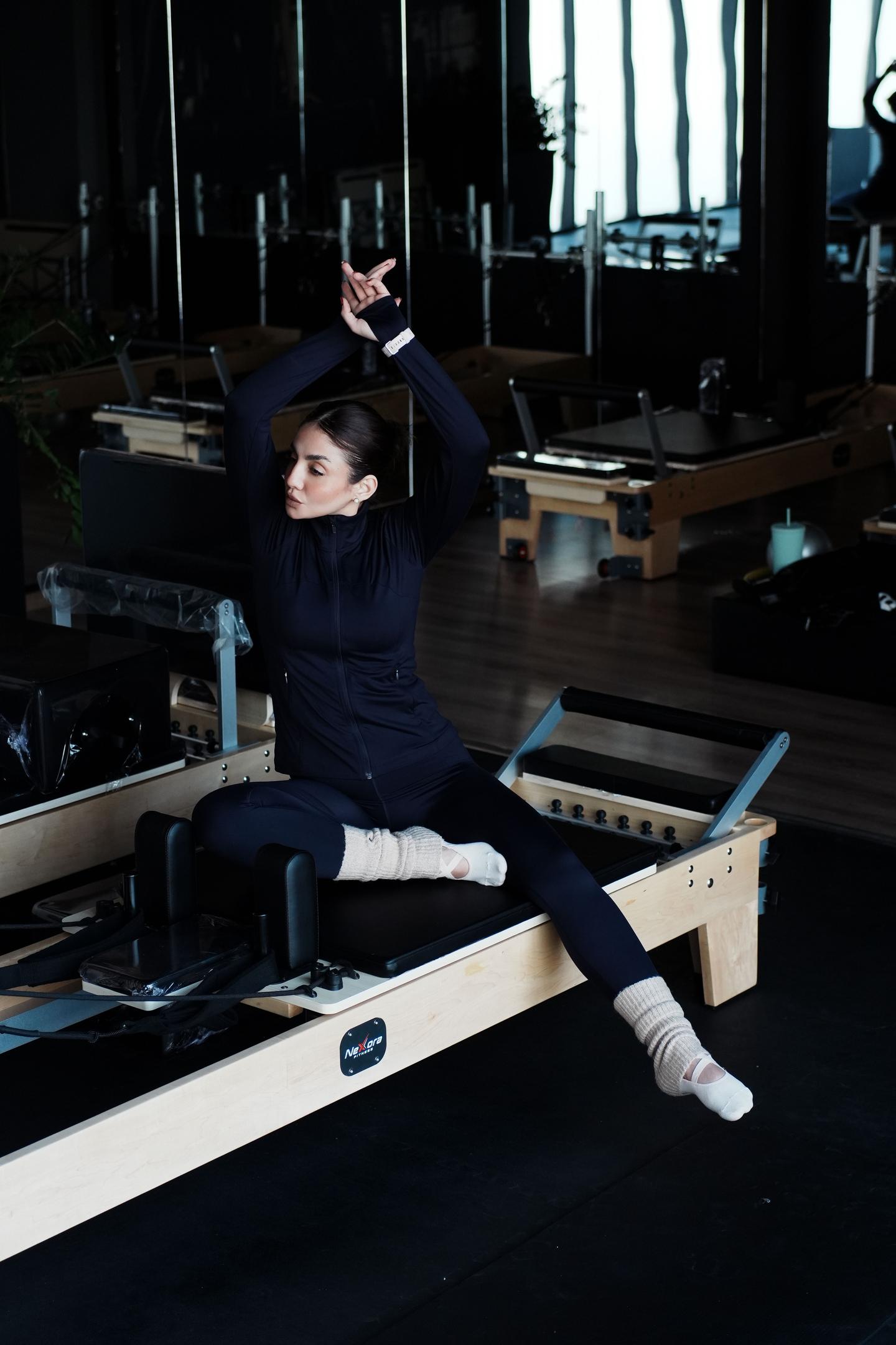 Girl stretching on a pilates reformer.