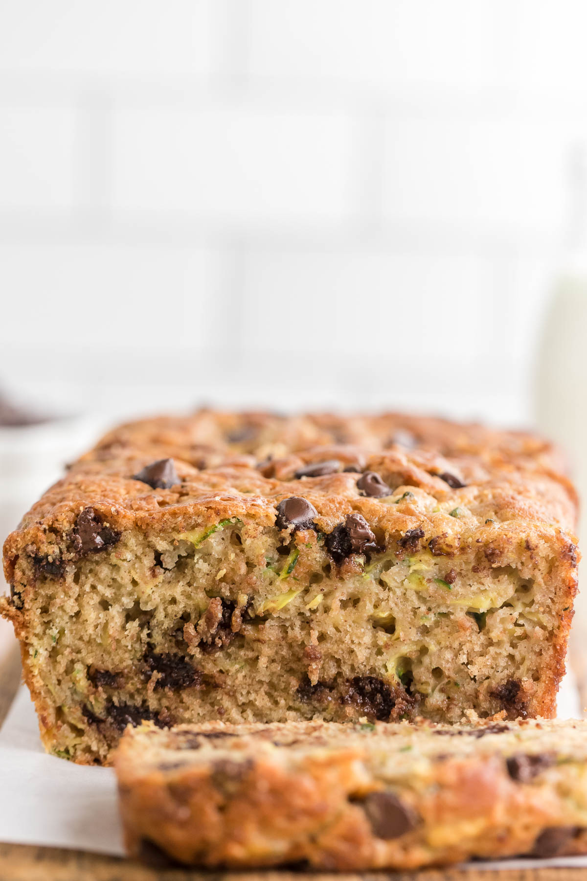 chocolate chip zucchini bread loaf sliced on a cooling rack