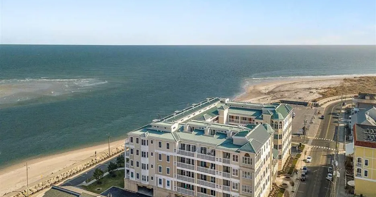 Aerial view of The Pointe at Moores Inlet in North Wildwood, New Jersey, showing the oceanfront condo building on Spruce Ave with panoramic views of Moore’s Inlet and the beach.