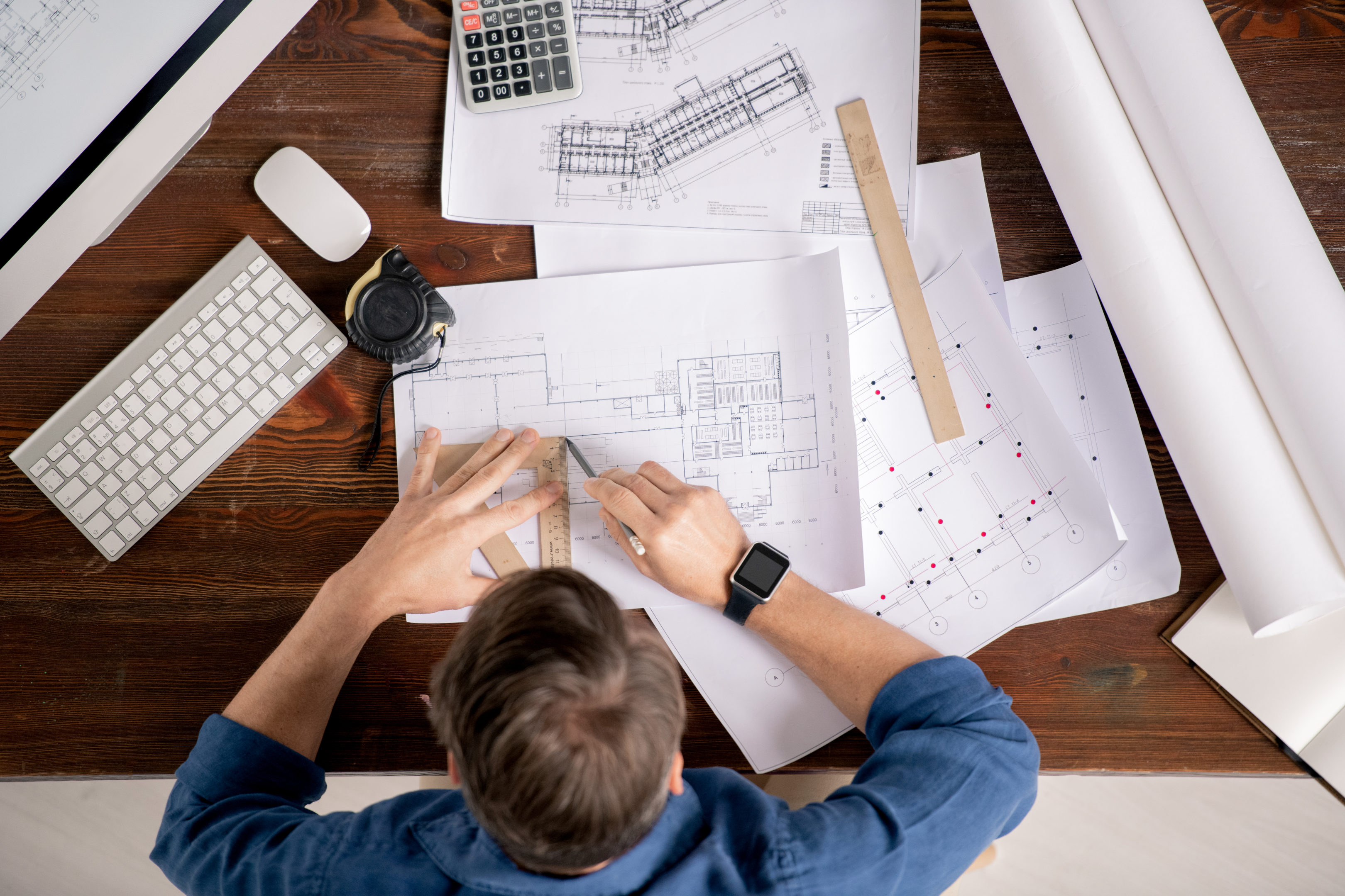 A licensed architect works hard on the thoughtful design of multiple house plans. 