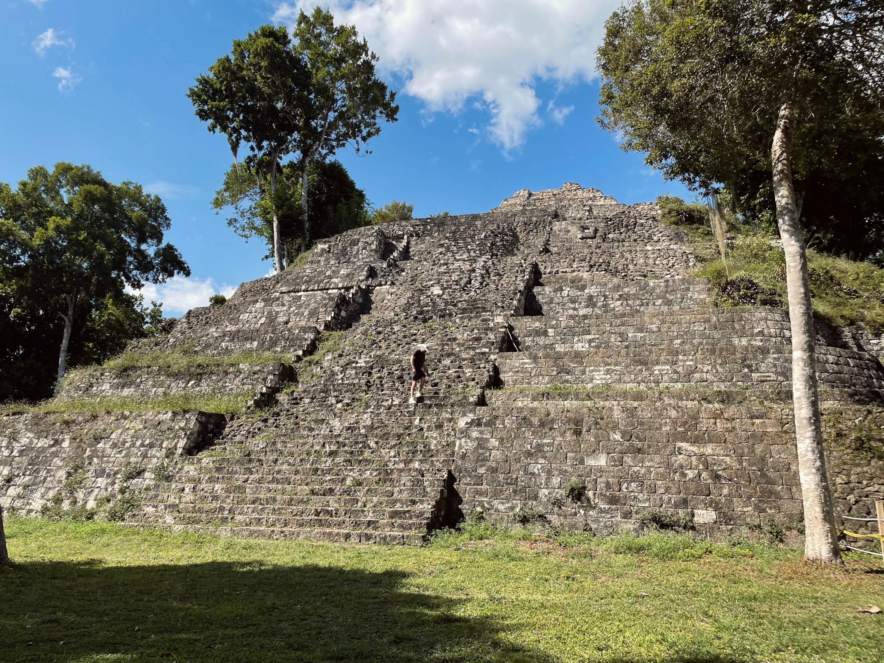 Climbing the stairs of a temple in Yaxha National Park, Guatemala