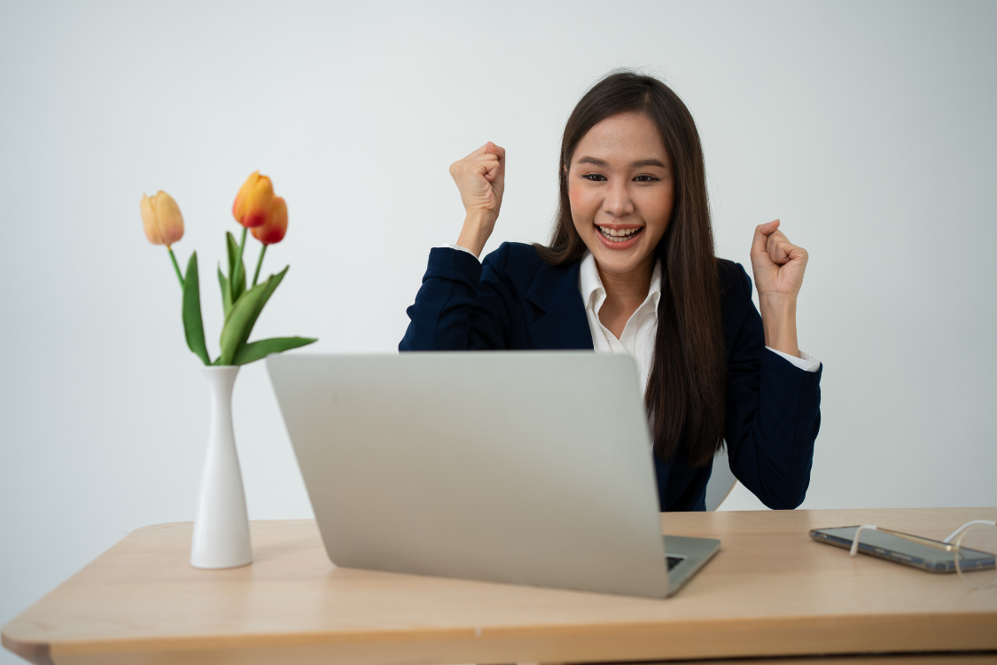 A Filipino remote job applicant celebrating success during an online assessment