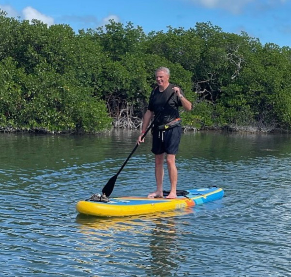 man on an inflatable paddle board