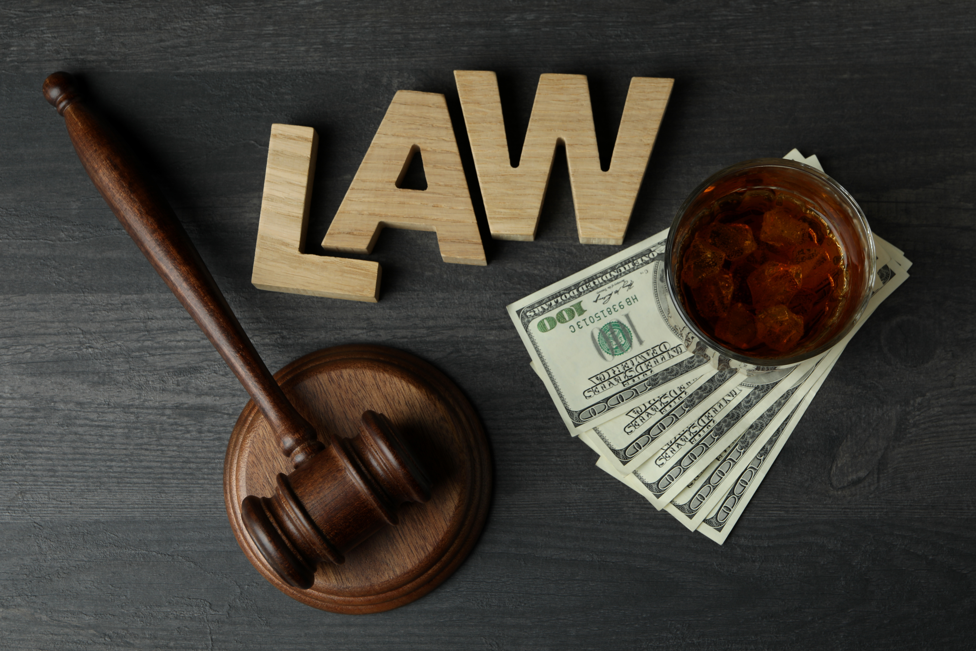 Judge's gavel poised on a dark wooden table, symbolizing the concept of law and justice.