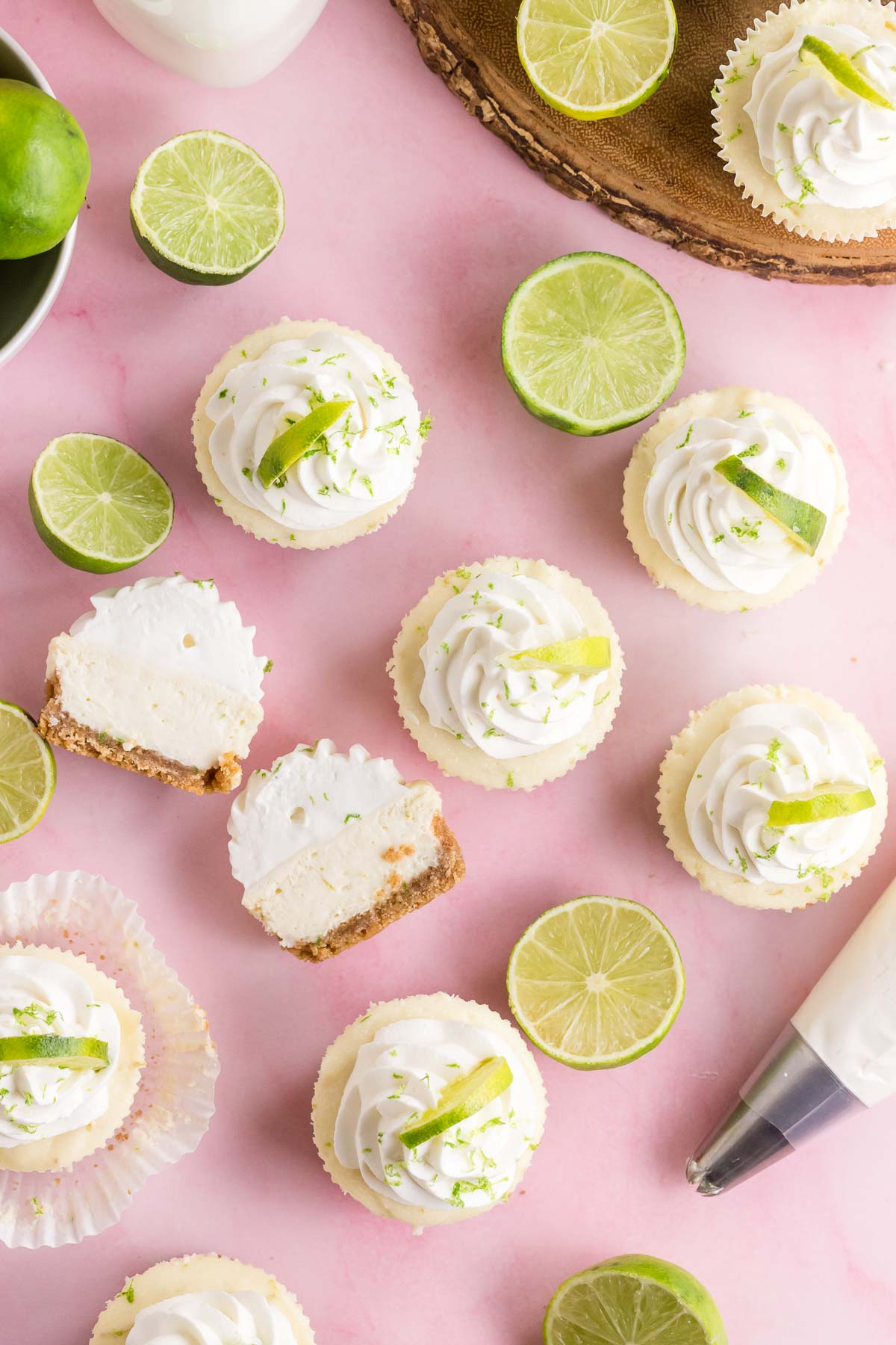 a bunch of mini key lime cheesecakes, and limes cut in half