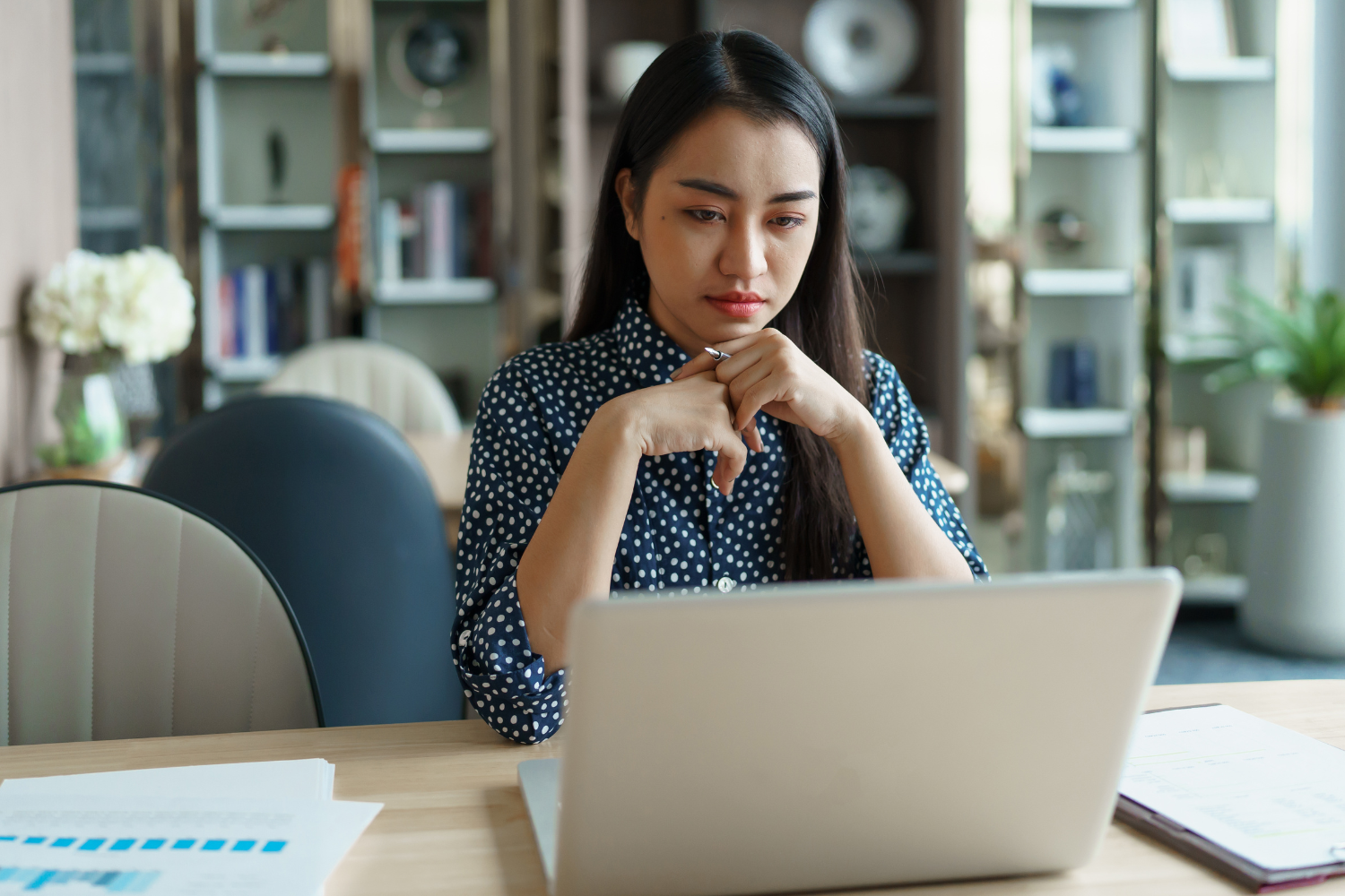 A remote employee hesitating before acting on a task.