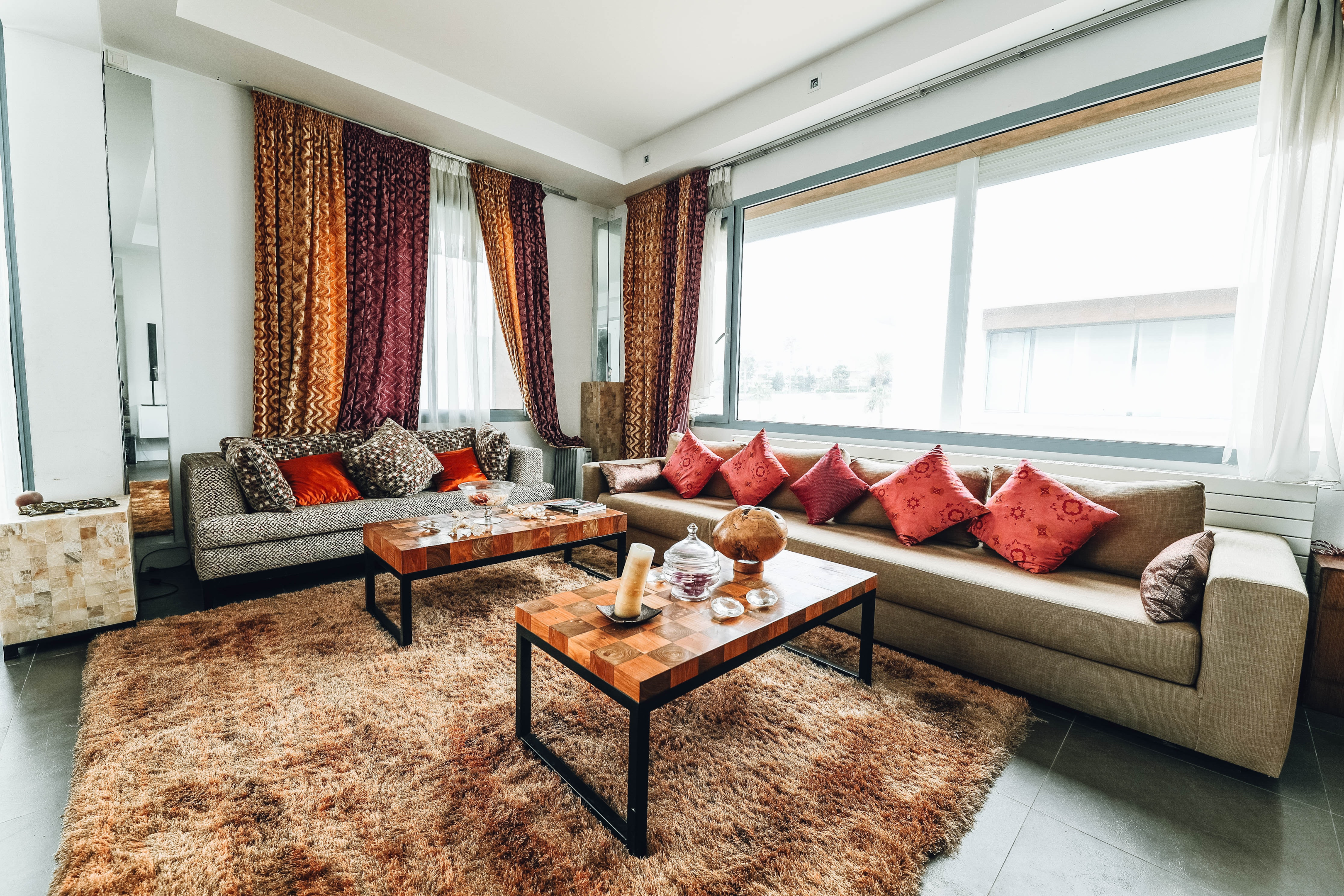 image credit: https://www.pexels.com/photo/brown-leather-sofa-with-red-pillows-near-windows-2029665/