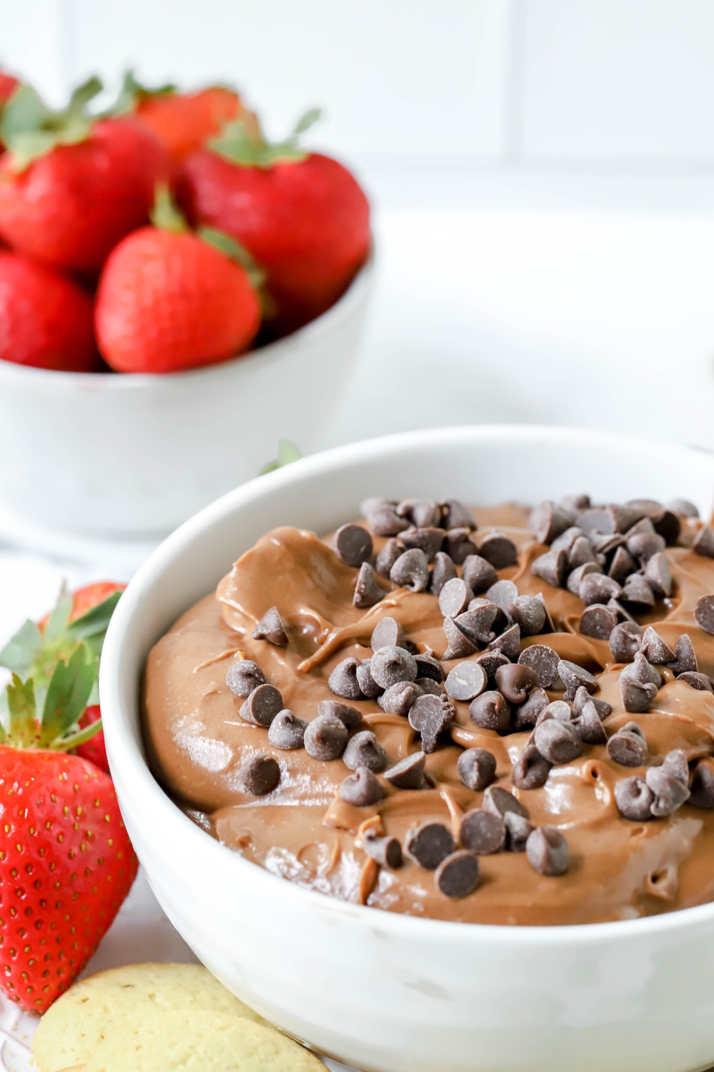 bowl of brownie batter dip and a bowl of fresh strawberries