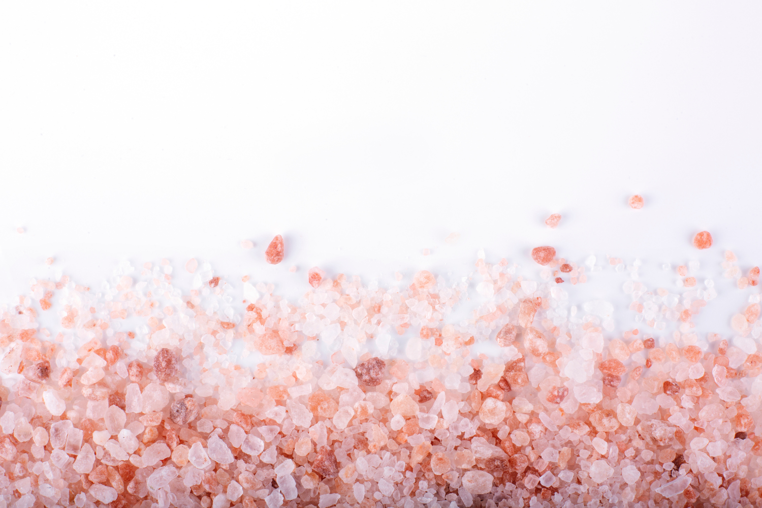 Himalayan salt crystals on white surface.
