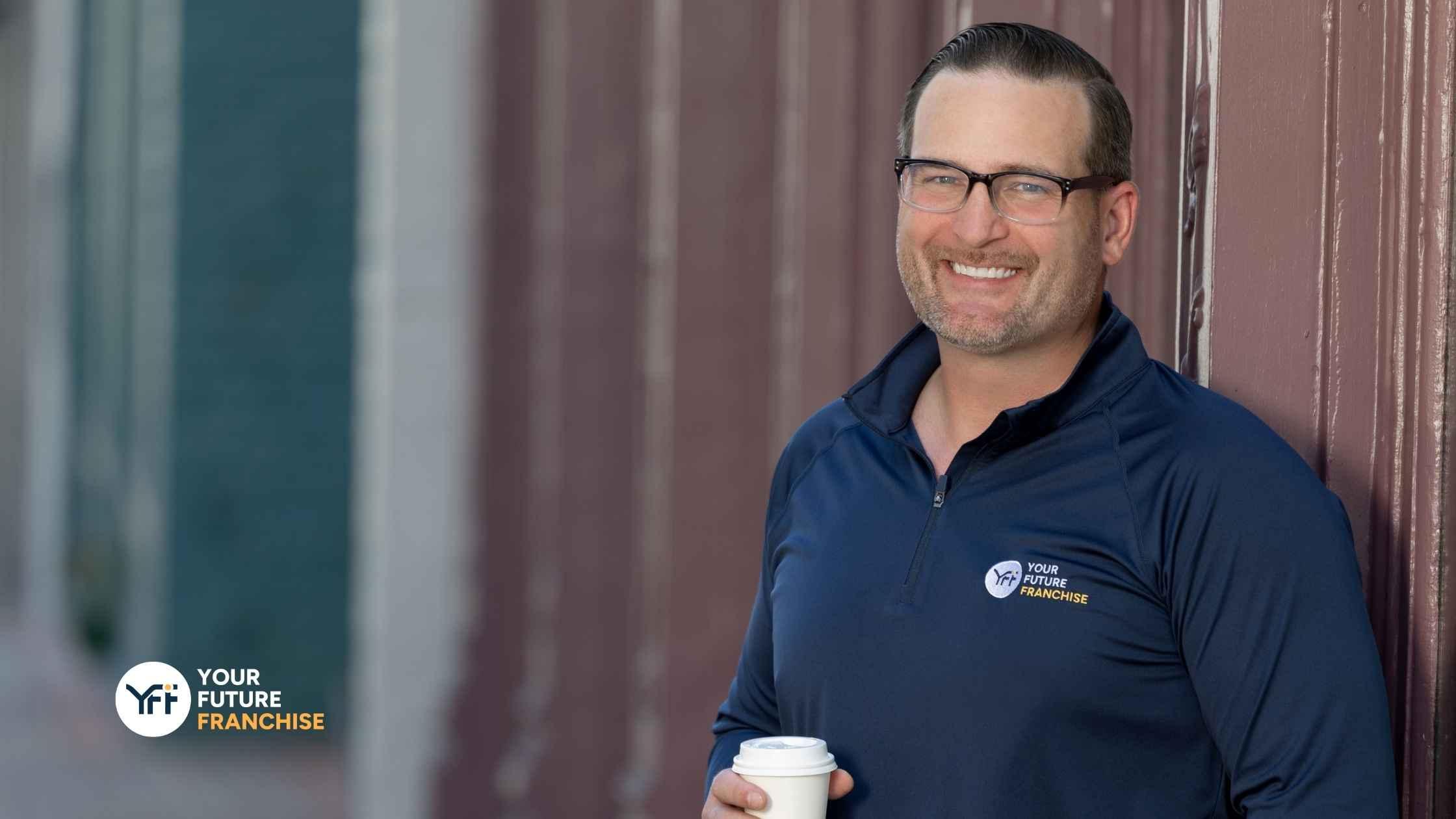 Scott Thompson smiling with Coffee