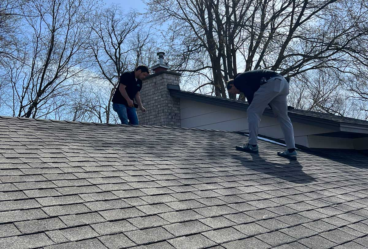 A roof inspection being conducted on a house