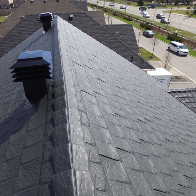 A close-up view of a black shingled metal roof.