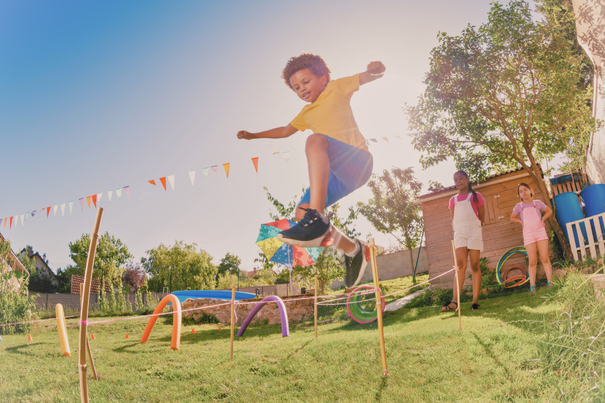 Child jumping over a hurdle