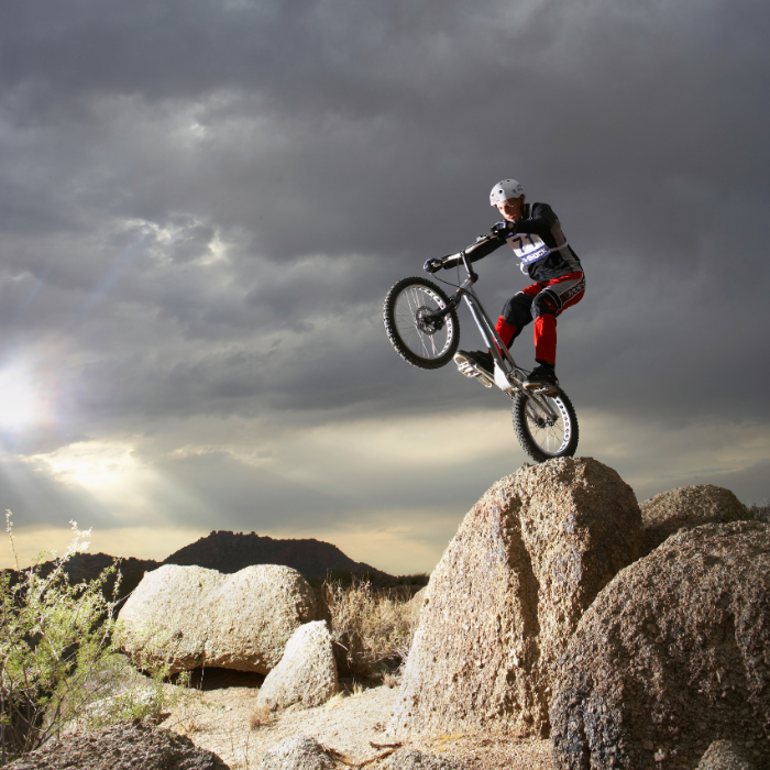 A mountain biker enhancing their wheelie prowess