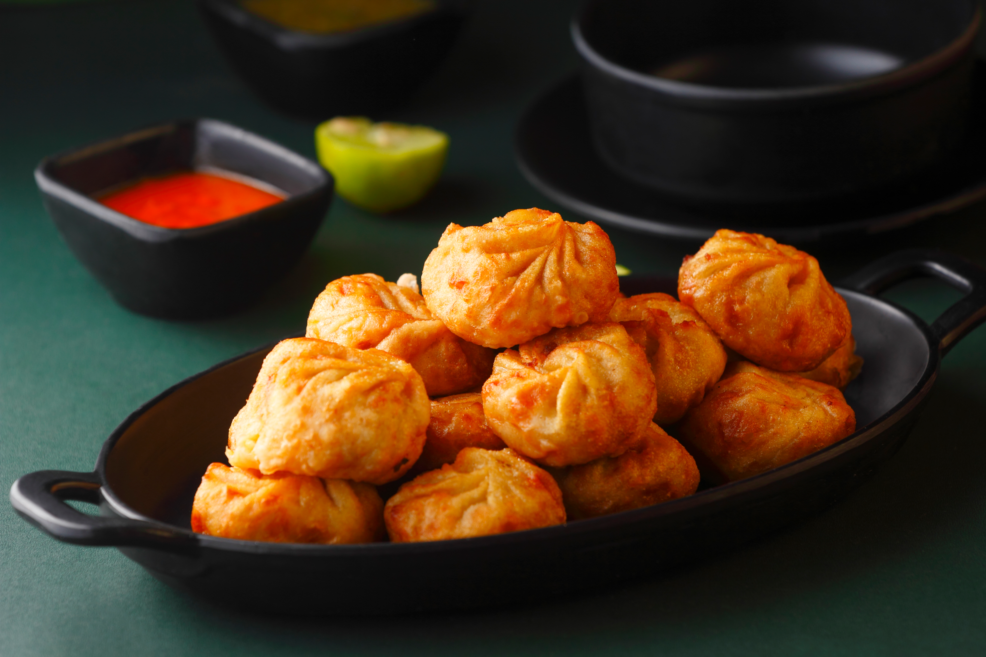 A plate filled with fried momos dumplings