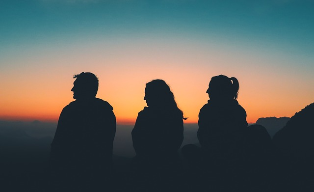 A group of friends with a sunset landscape in the background 