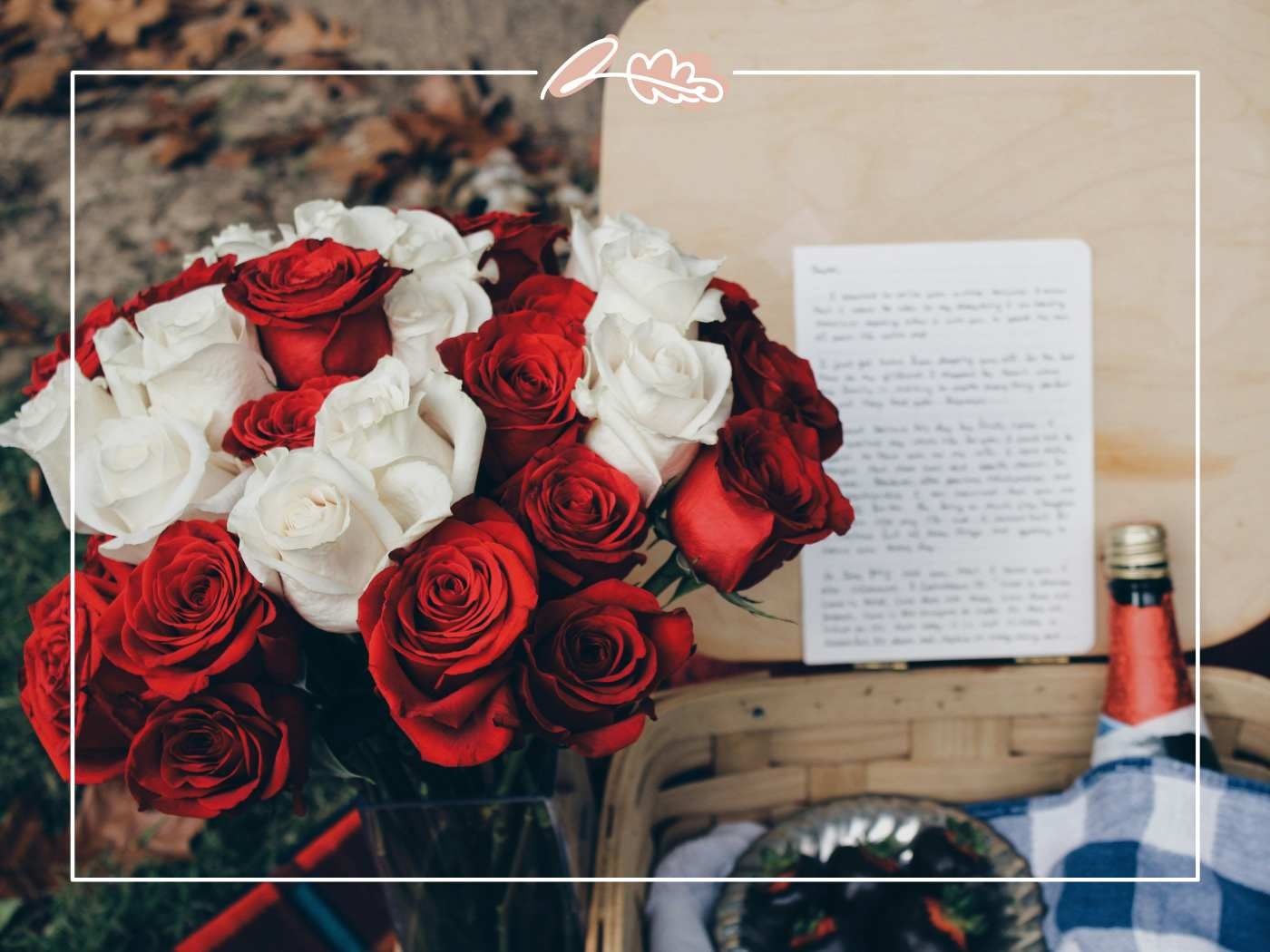 Red and white roses in a basket with a handwritten note.