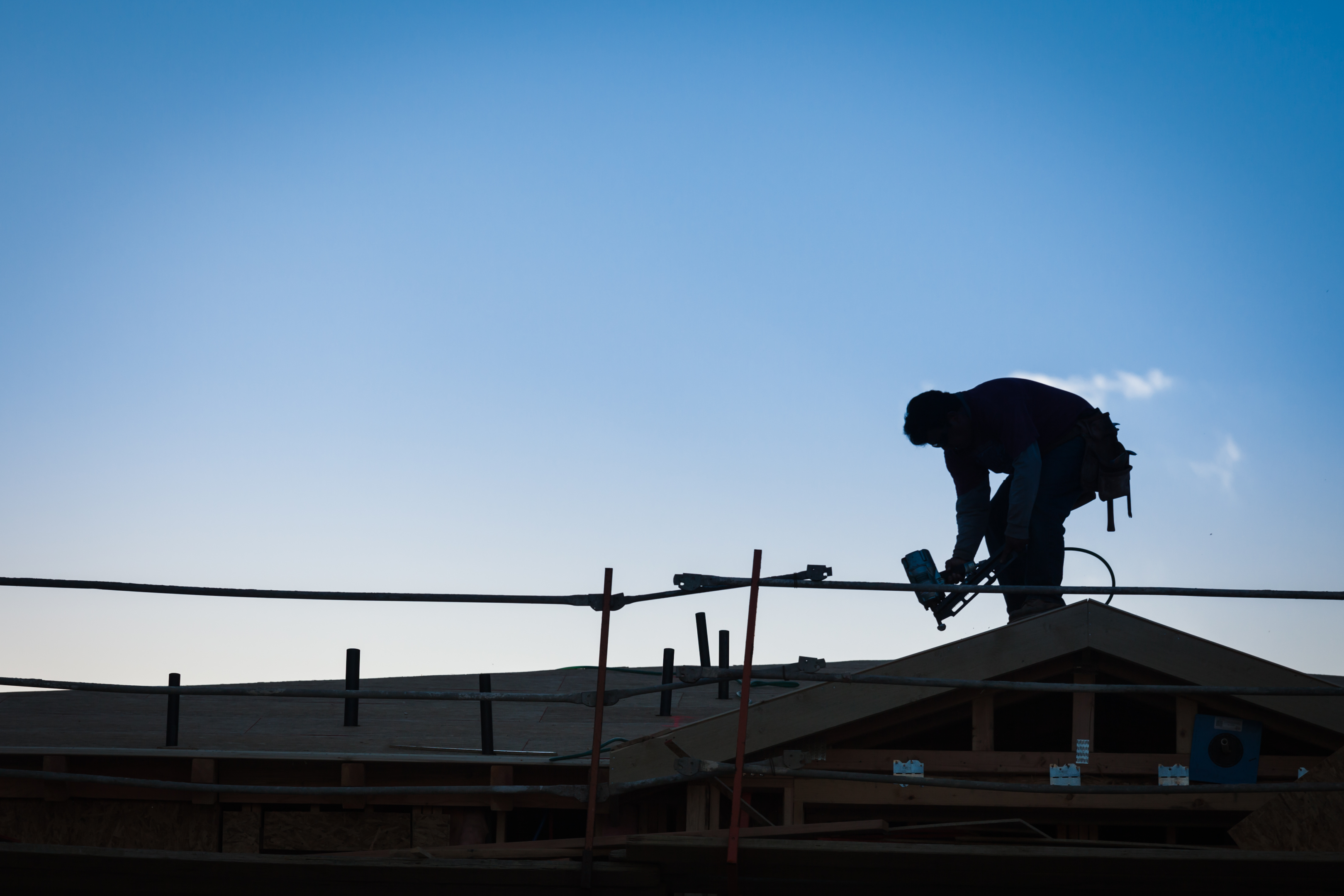 Silhouette of a roofing contractor