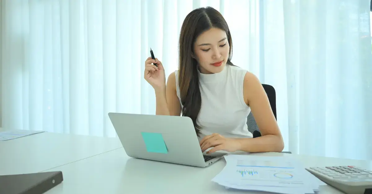 Woman reviewing receipts and tracking expenses for an accountable plan to reduce taxable income.