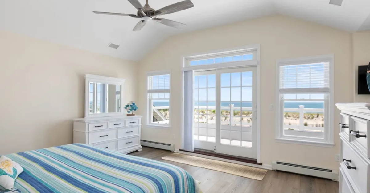 Bright coastal bedroom with ocean view balcony in a Seaside Park NJ vacation rental home