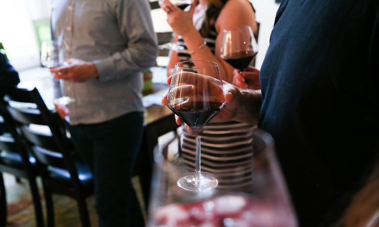 Group of people learning wine pairing in a cooking class in Austin