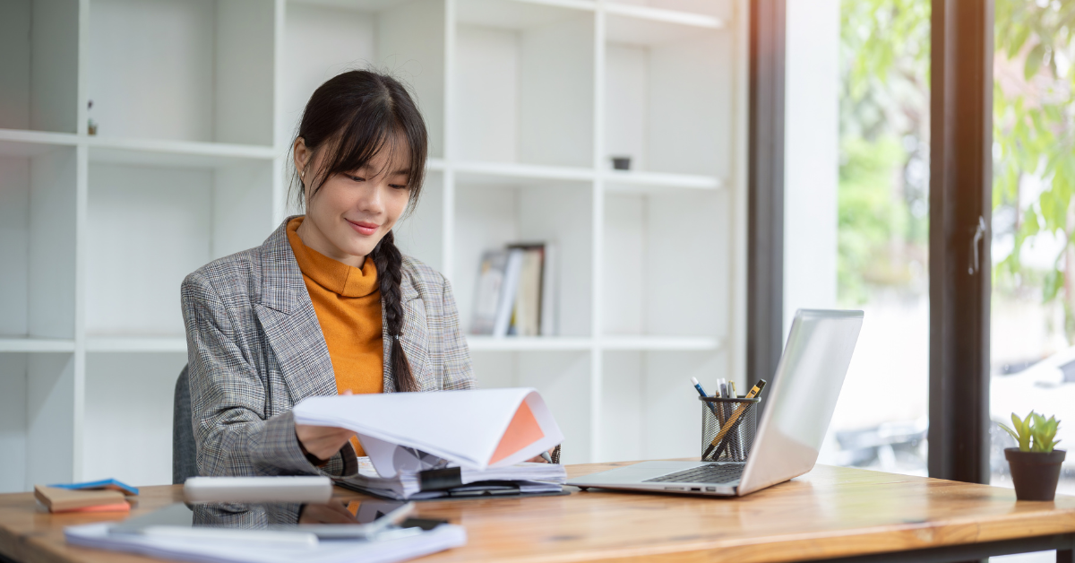 Woman using a general ledger for small business to track income and expenses efficiently.