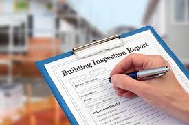 A detailed building and pest inspection report attached to a clipboard, held by an inspector with visible sections on structural assessments and pest findings