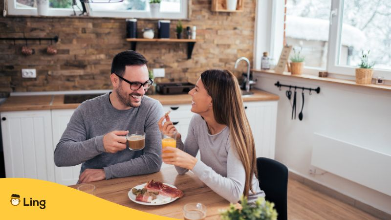 Sweet couple in the morning in the kitchen having a good time