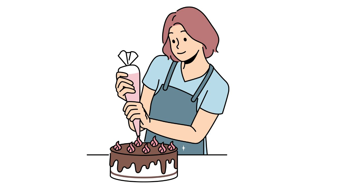 A cake decorator decorating a cake