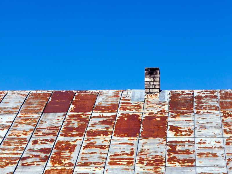 Image showing a homeowner relieved after solving metal roofing issues in San Antonio.