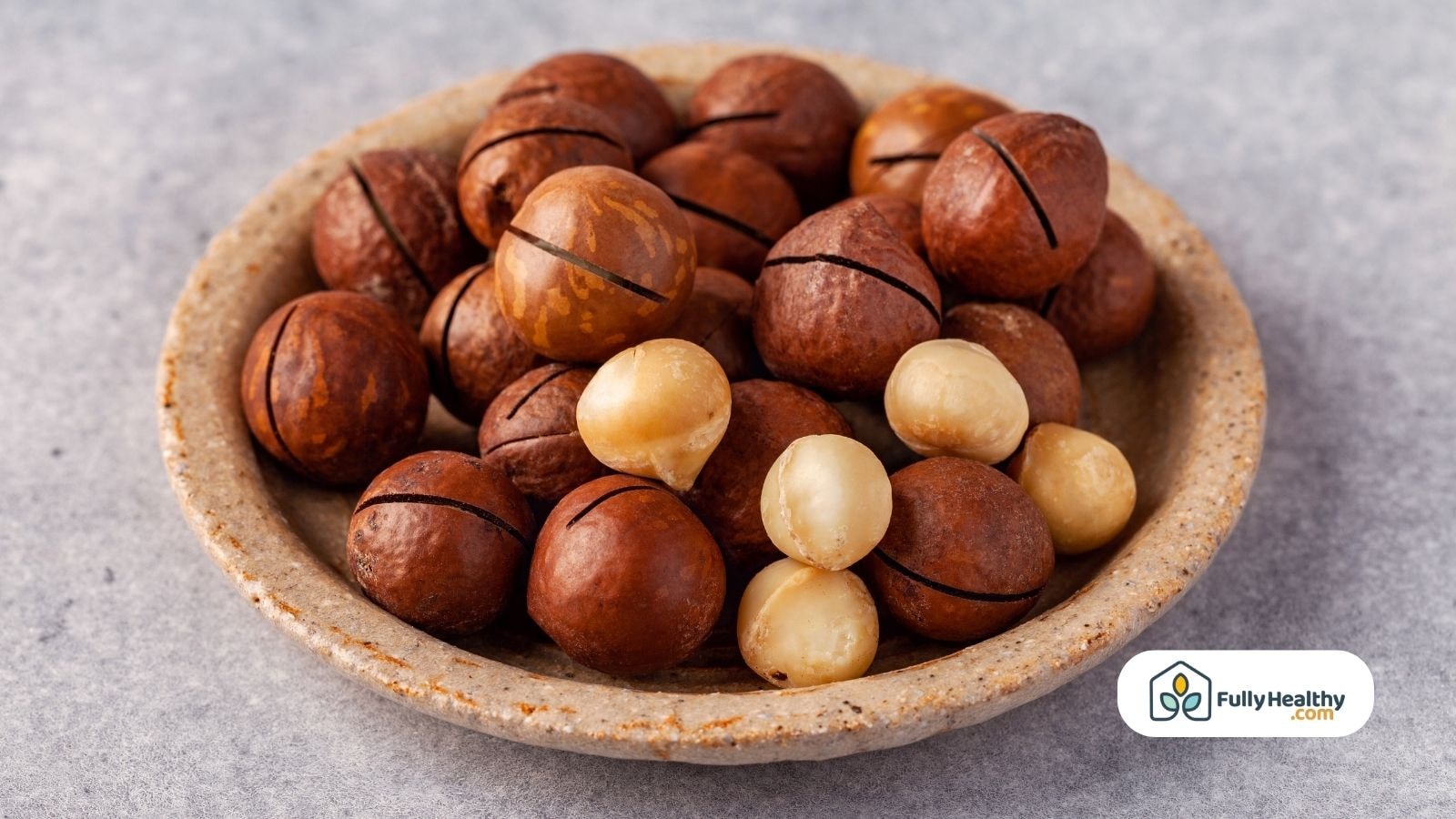 Close-up of raw and shelled macadamia nuts in a ceramic bowl