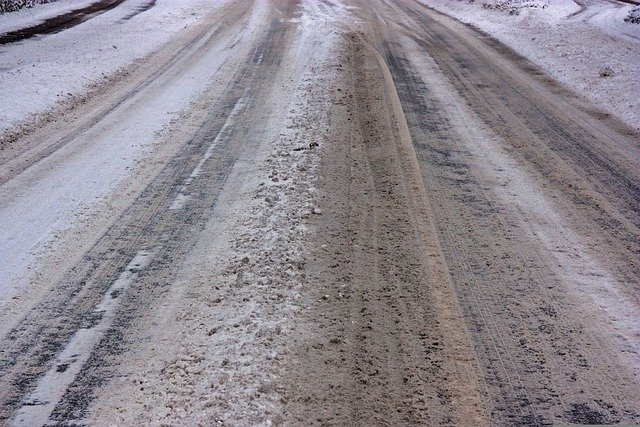 Winter road treated with a brine solution.