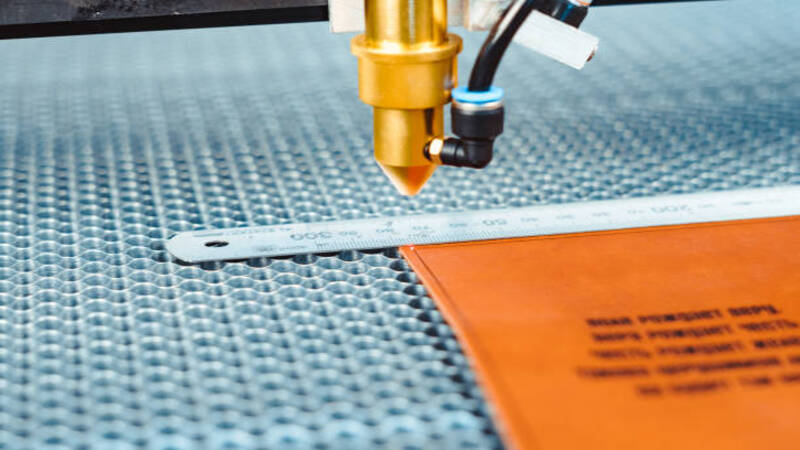 The laser cutter cuts the edges of the leather along the path.
