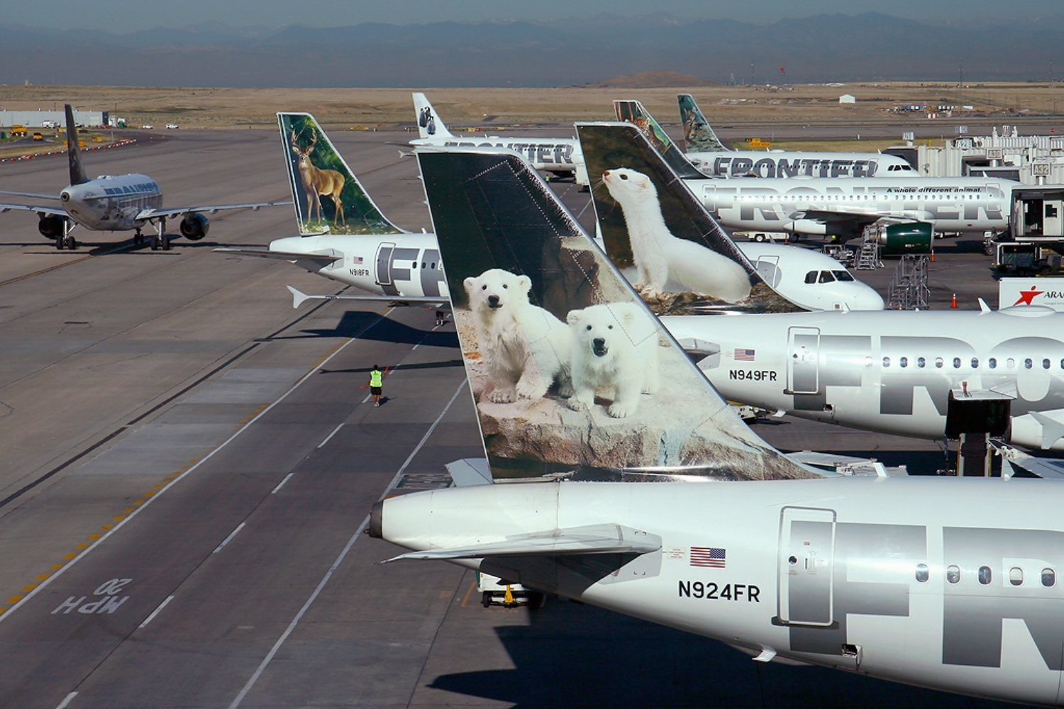 seven frontier aircrafts at an airport: why is frontier so cheap