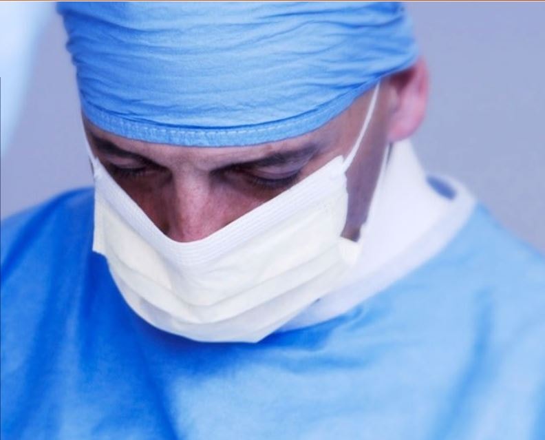 Board Certified Oral Surgeon consulting patient for Wisdom Teeth Removal