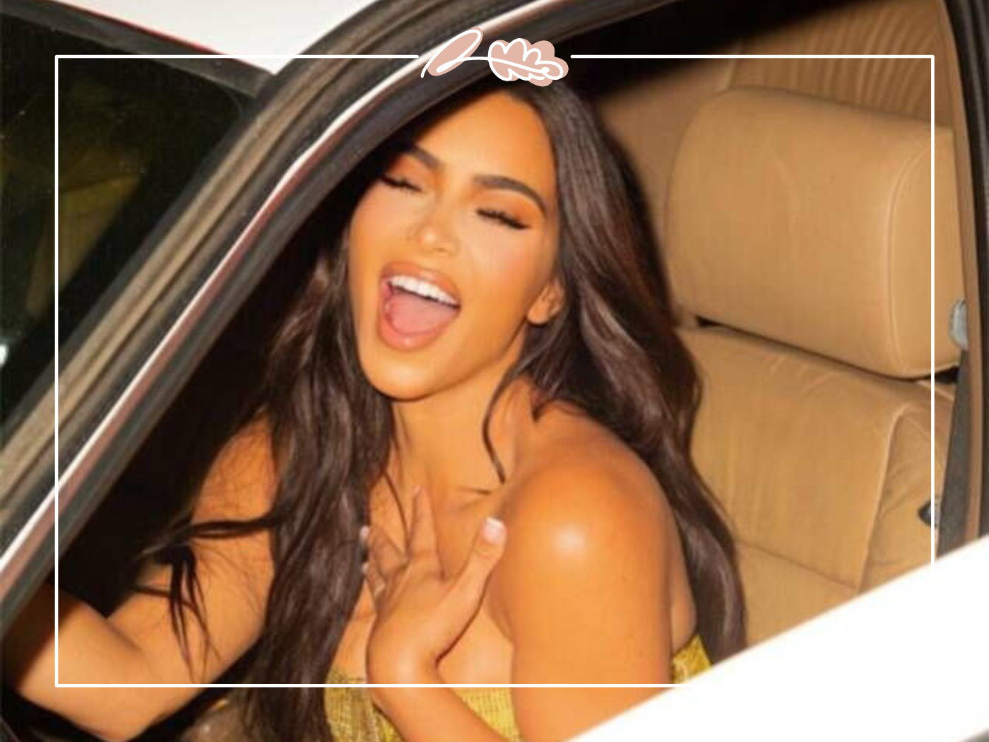 Kim Kardashian smiling while sitting in a car, showing her lively and glamorous personality. Fabulous Flowers and Gifts.