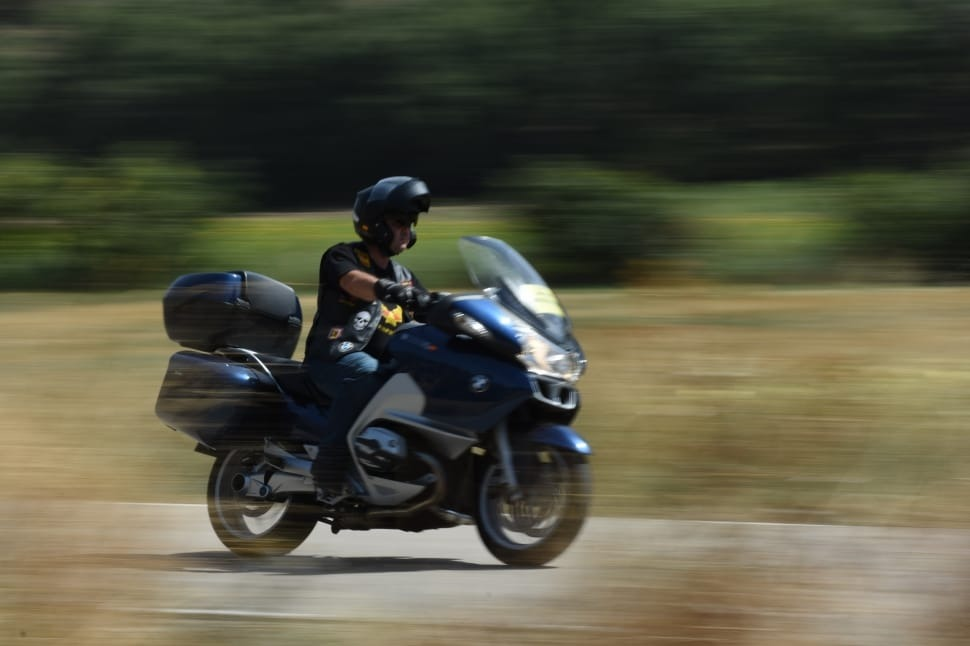 Person driving a black touring motorcycle