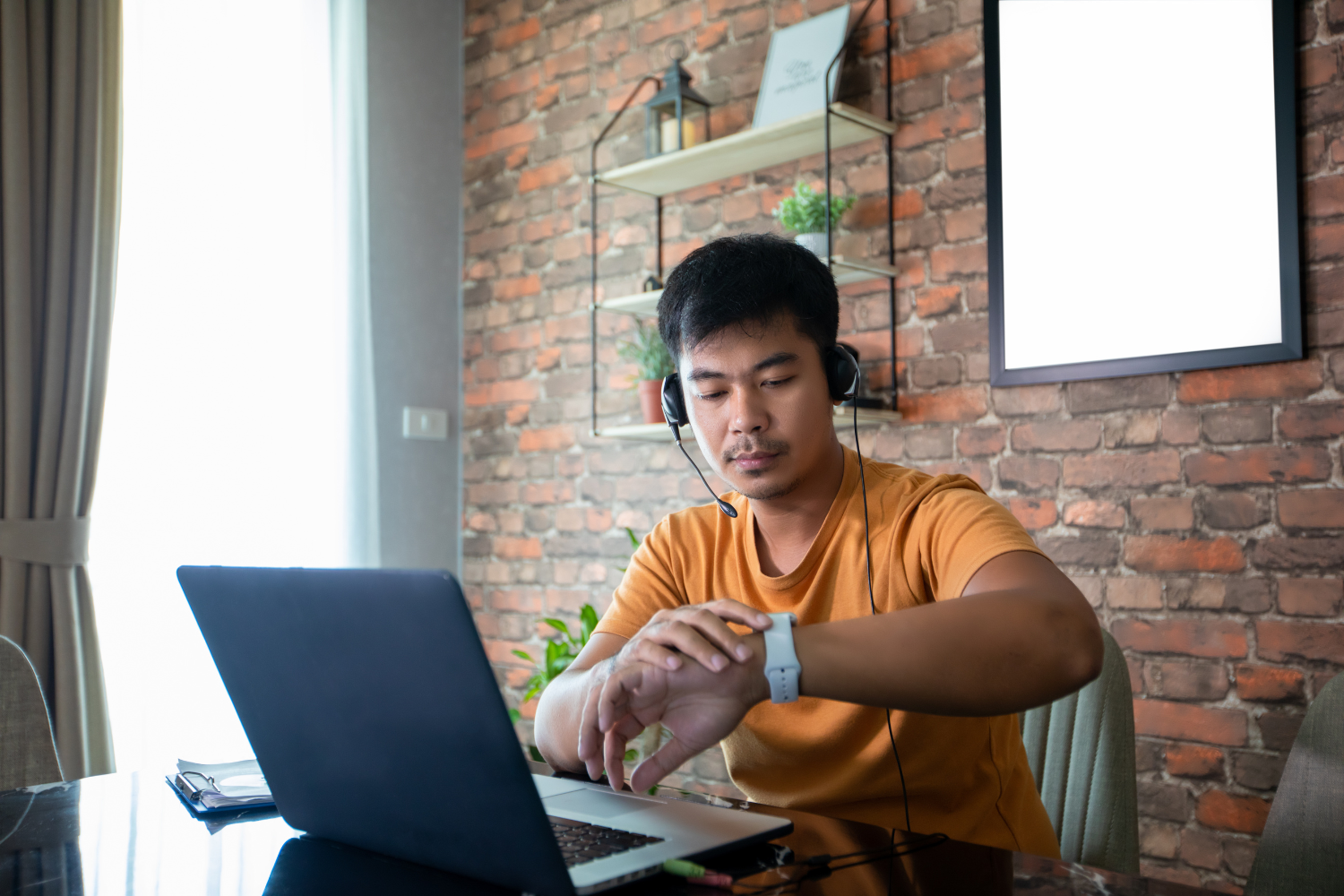 A remote worker in the Philippines working from home on a laptop.
