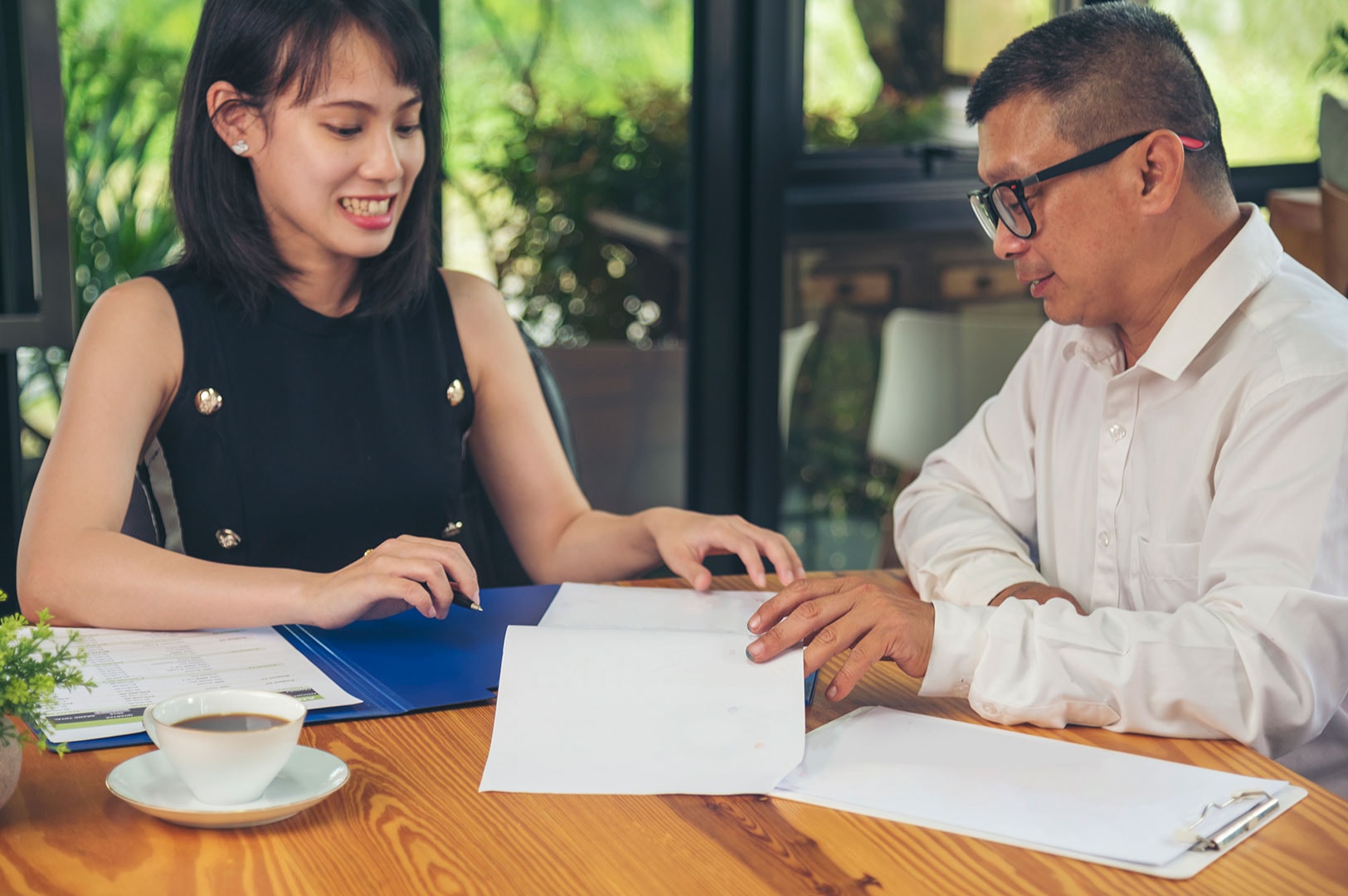 Employer consulting with agency representative about hiring a helper.