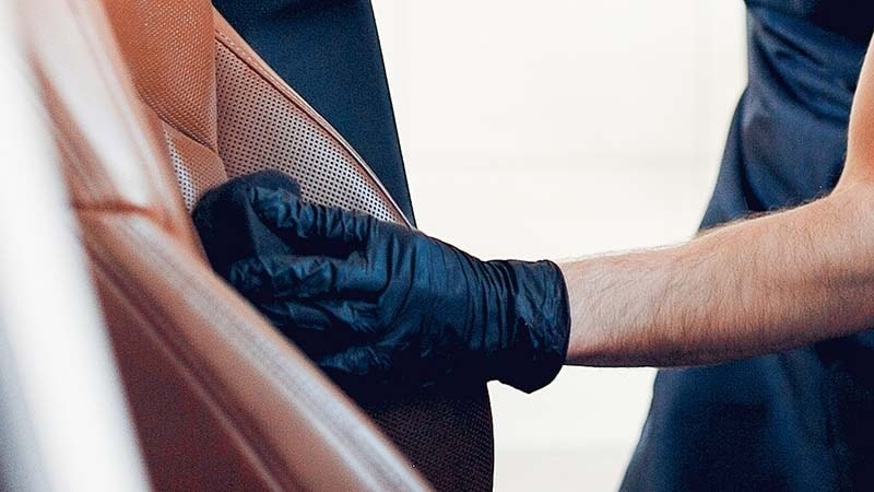 Man Wiping the leather car seat