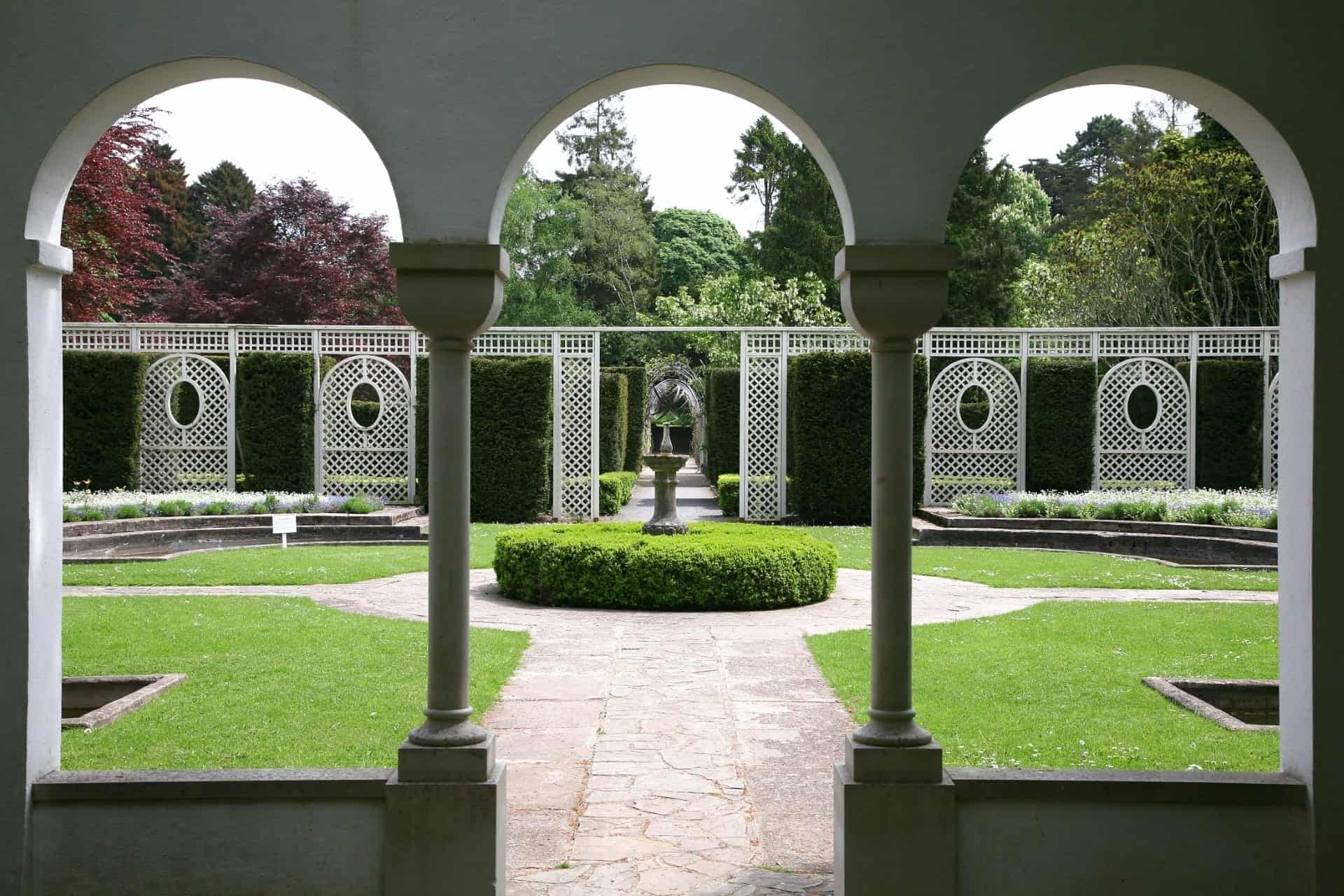 view of a formal garden through an archway