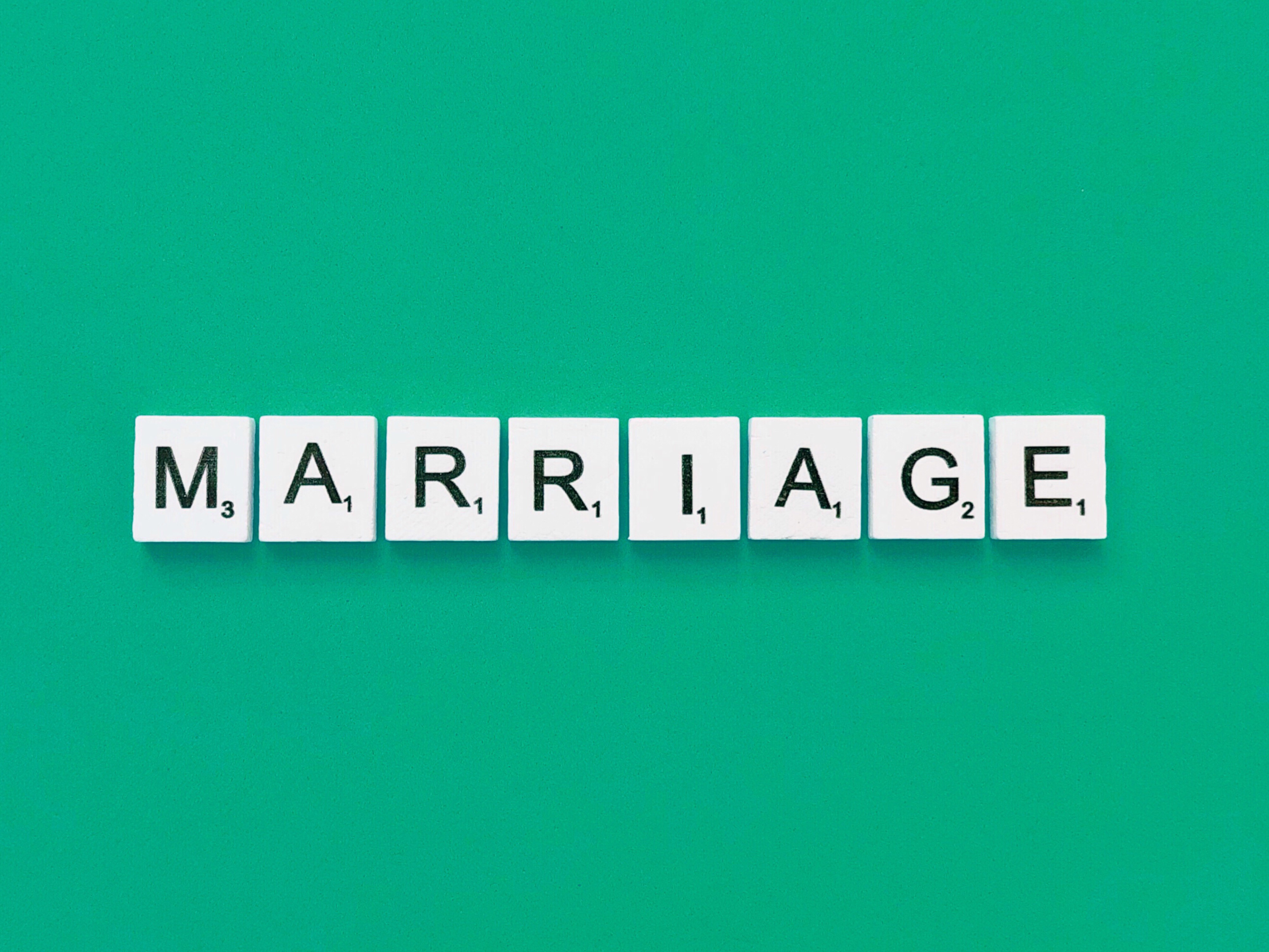  "Block letters spelling 'Marriage', symbolizing a significant life change."