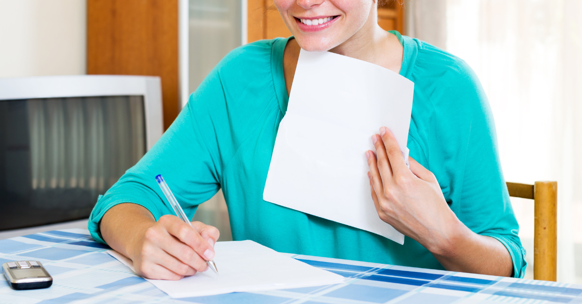 Woman filling out partnership tax return form.