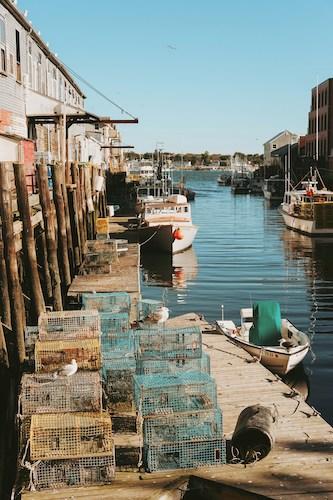 Lobster traps and fishing boats along a dock in Old Port