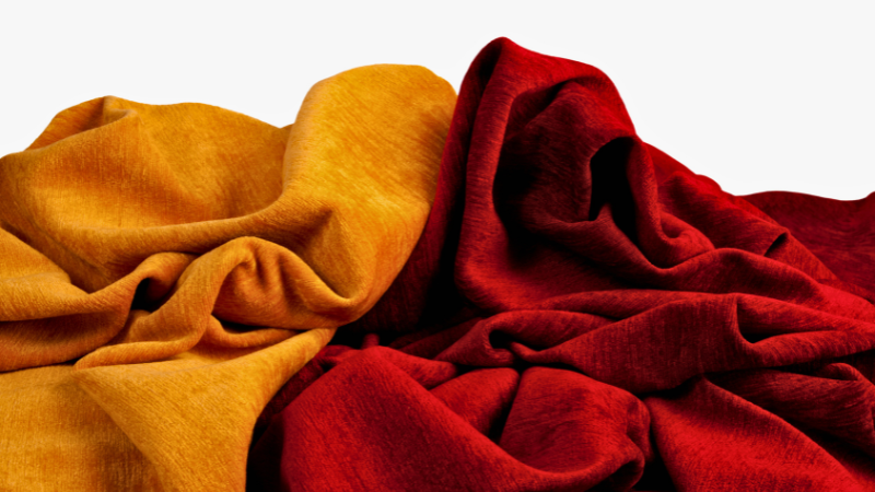 A pile of red and yellow Cupro cloths on a white background