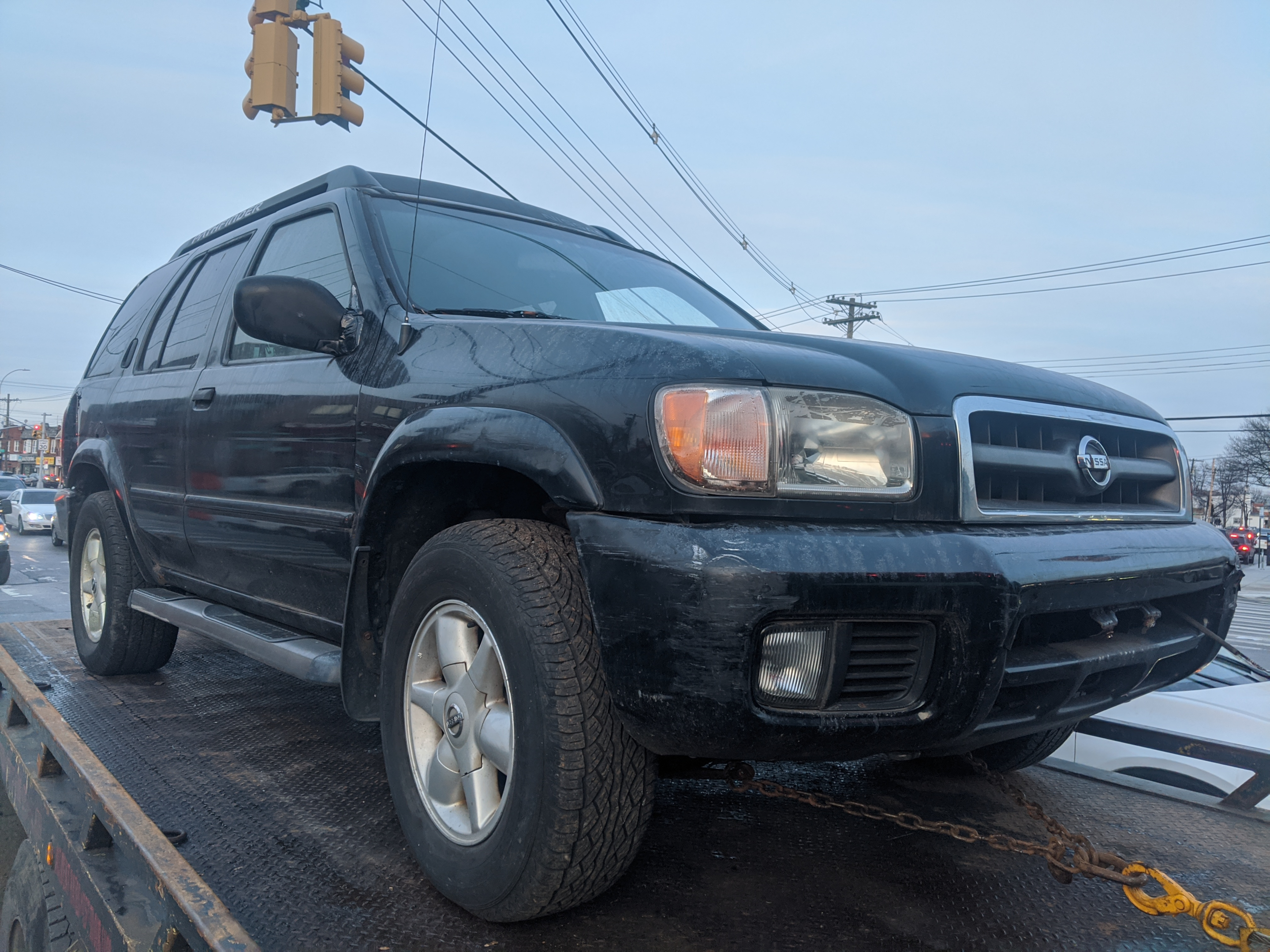 A photo of a car being towed away by a junkyard truck, representing the process of selling your car to a junkyard." The keyword "sell car to junkyard" is included in the alt text.