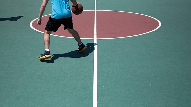 basketball player dribbling on outdoor court