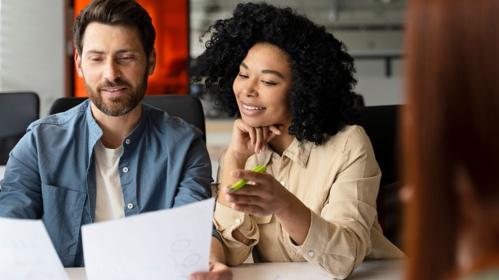 A group of people discussing a business plan